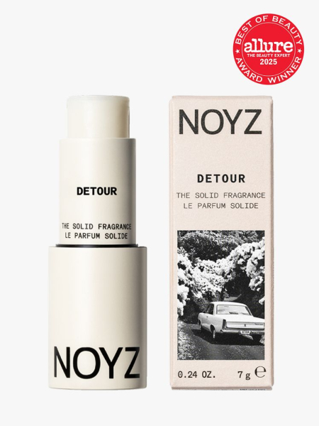 NOYZ The Solid Fragrance in branded off white bottle with cap next to box packaging on light gray background with red Allure Best of Beauty seal in the top right corner